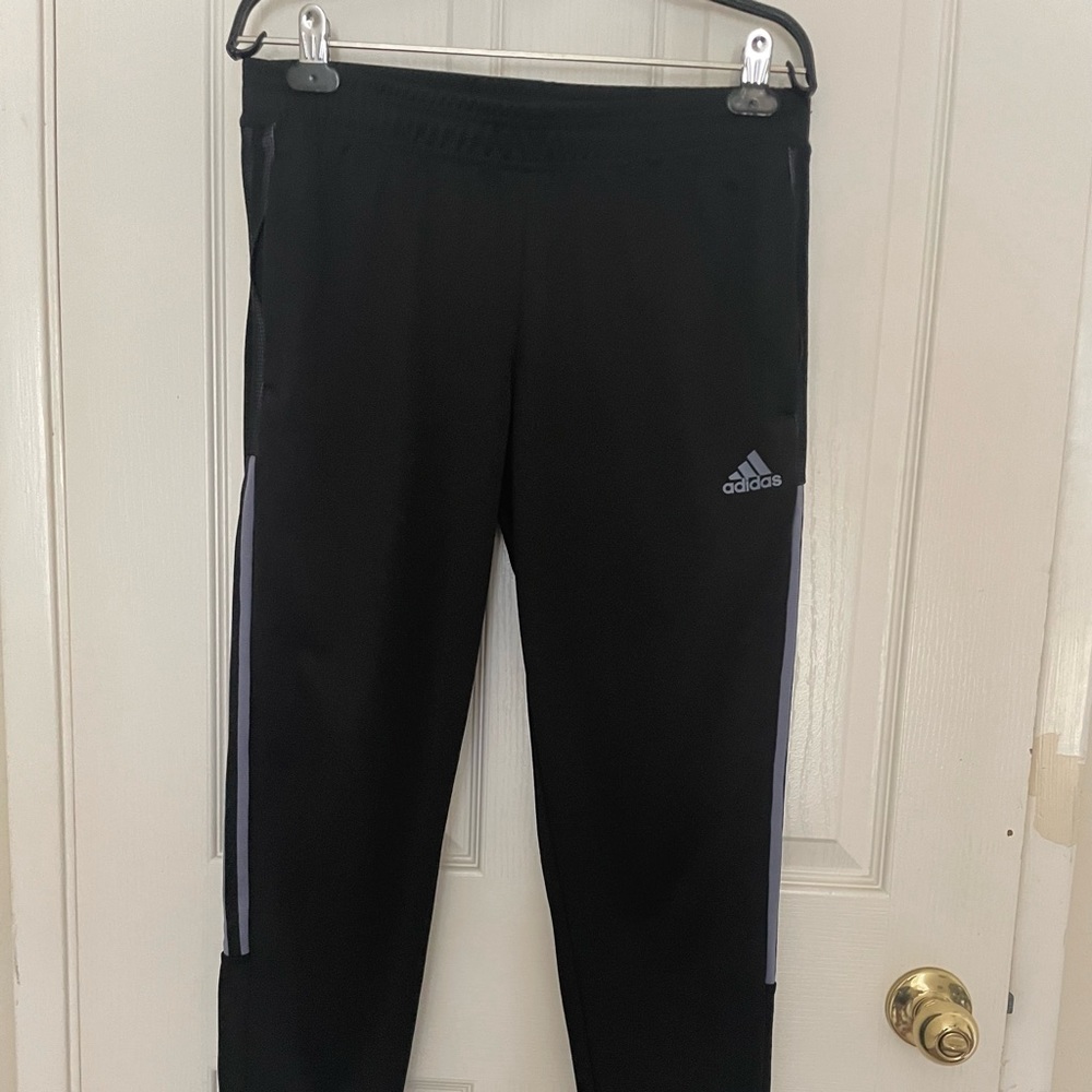 Adidas black with light blue strips.
